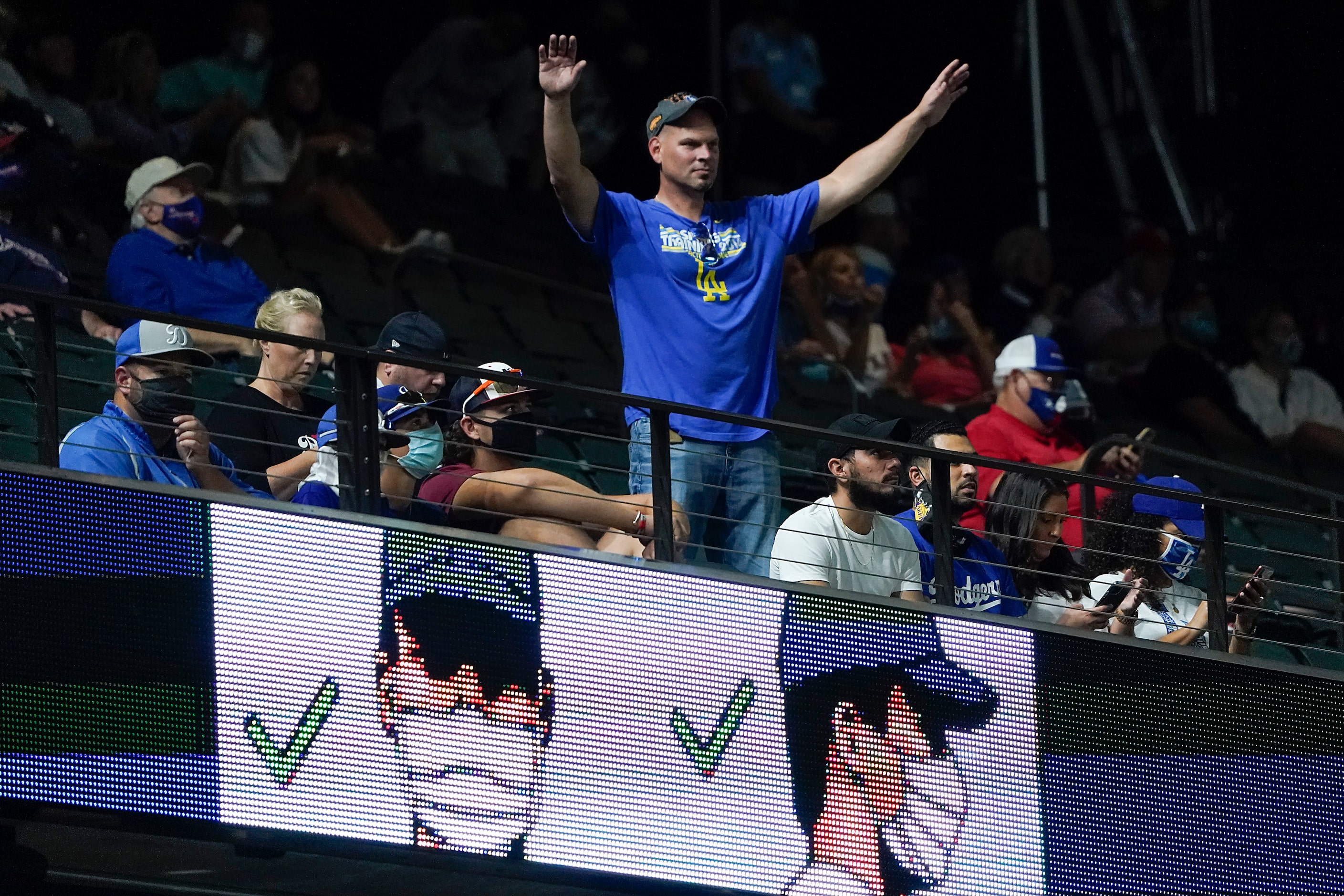 A Los Angeles Dodgers fan cheers as his team take the field to face the Atlanta Braves...