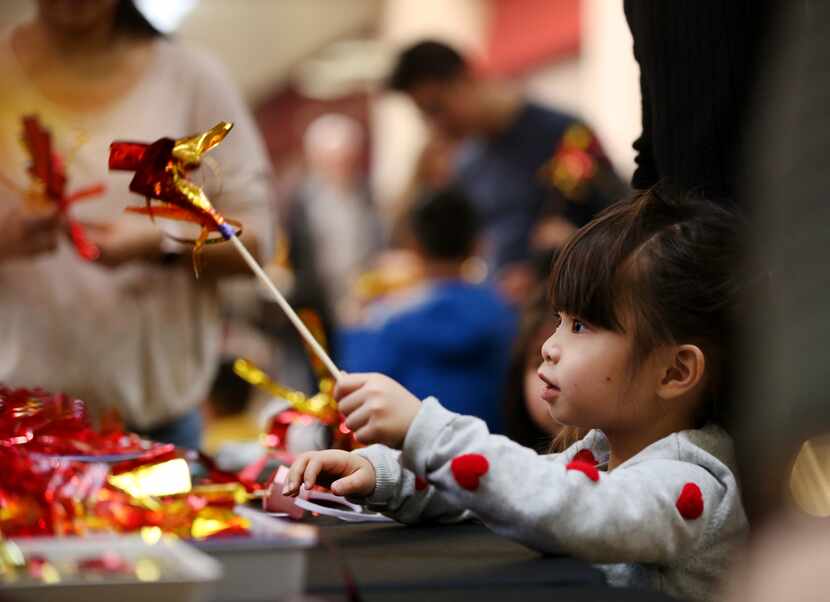 Nghi Trinh plays with firework art at the Chinese New Year Festival at NorthPark Center in...