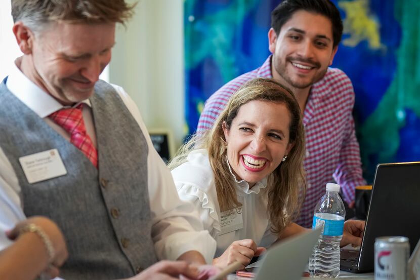 Realtor Maria Rendon laughs with colleagues during a weekly small working peer group meeting...