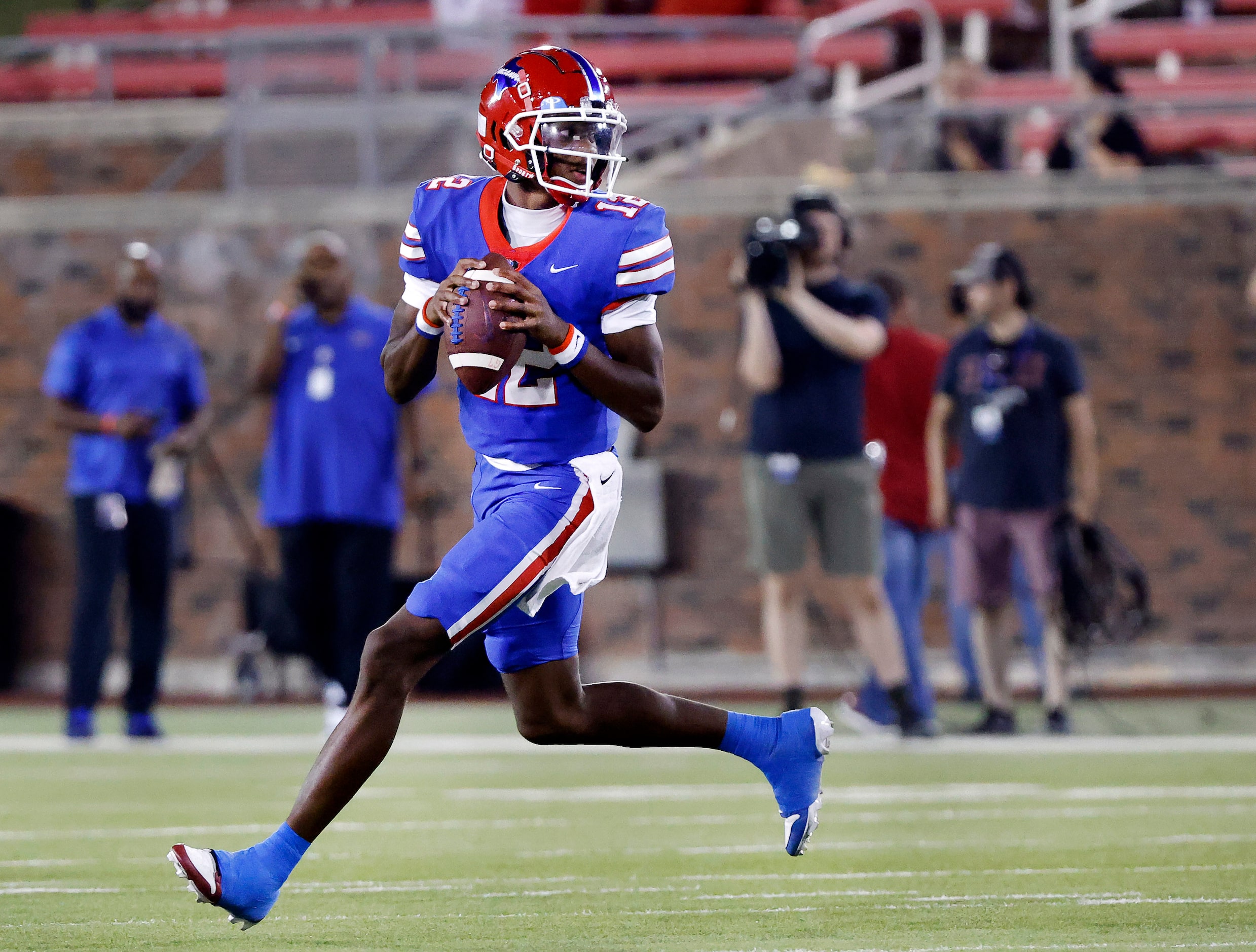 Duncanville quarterback Keelon Russell (12) rolls out looking for receiver against South Oak...