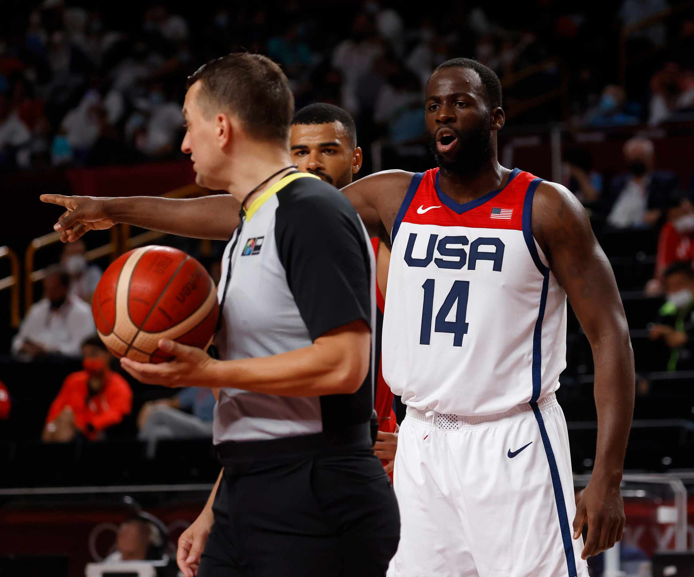 USA’s Draymond Green (14) questions a call from a referee in a game against France during...