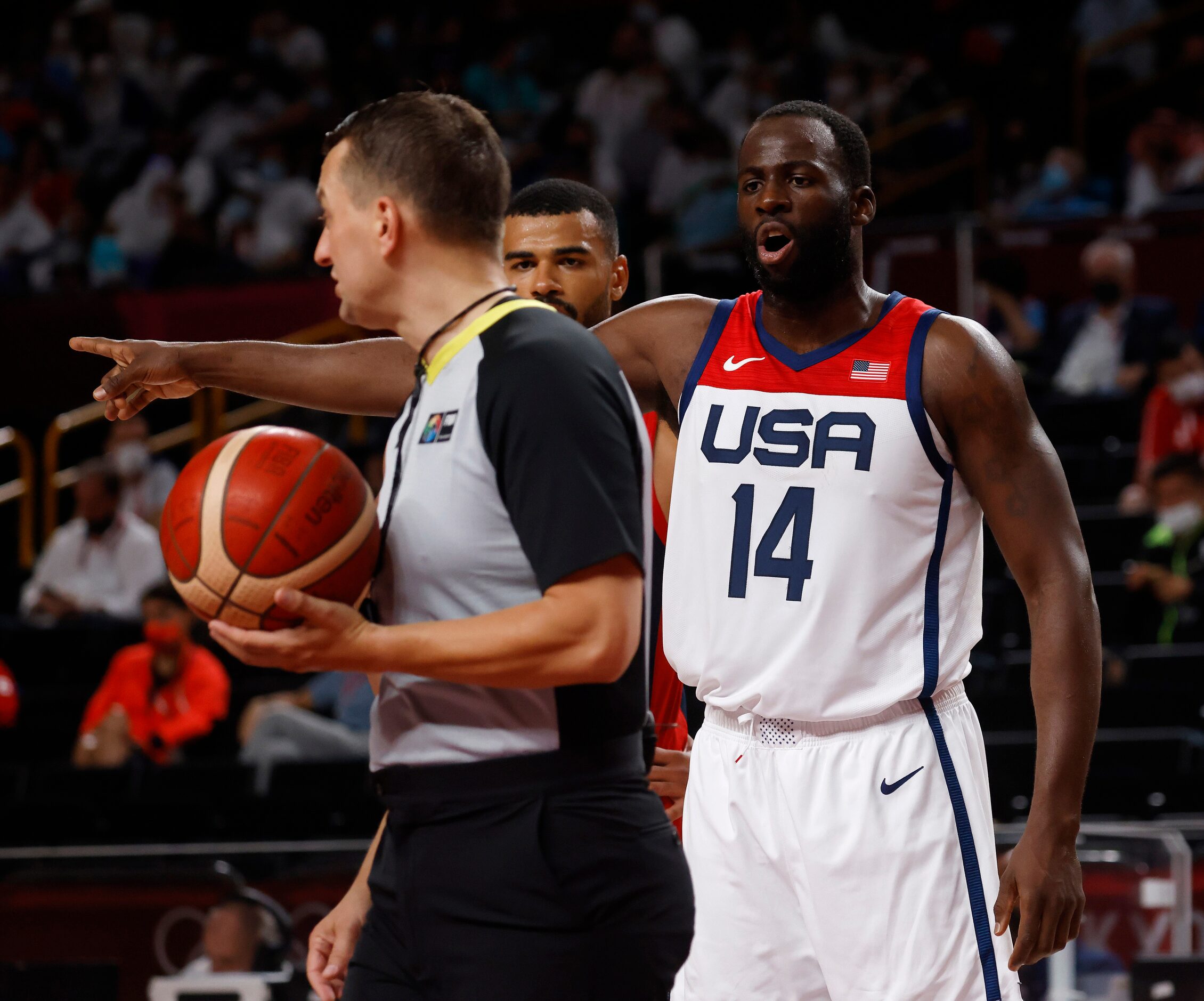 USA’s Draymond Green (14) questions a call from a referee in a game against France during...