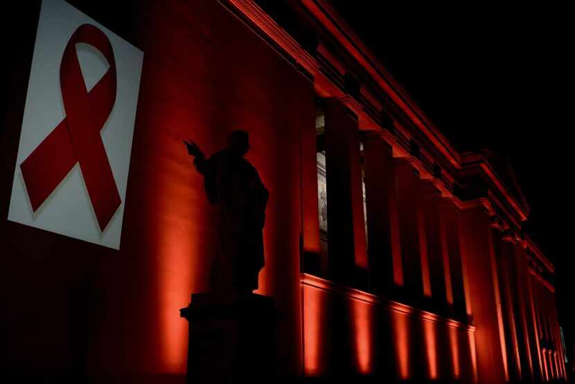 The National and Kapodistrian University of Athens is illuminated with a red light by the...