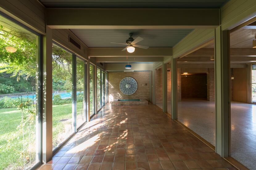 Floor-to-ceiling windows, terra cotta tile floors and covered verandas are signatures of...