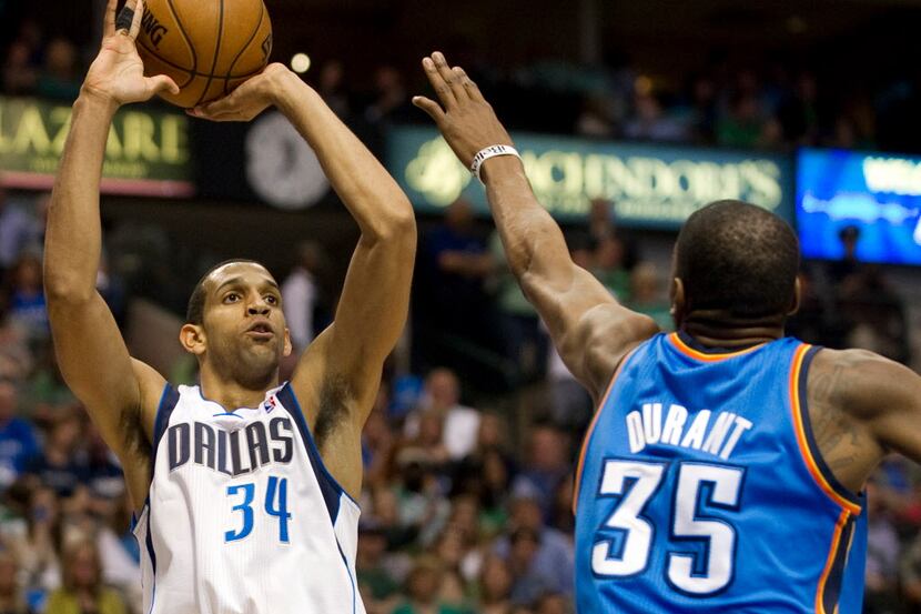 Brandan Wright (34) of the Dallas Mavericks shoots the ball over Kevin Durant (35) of the...
