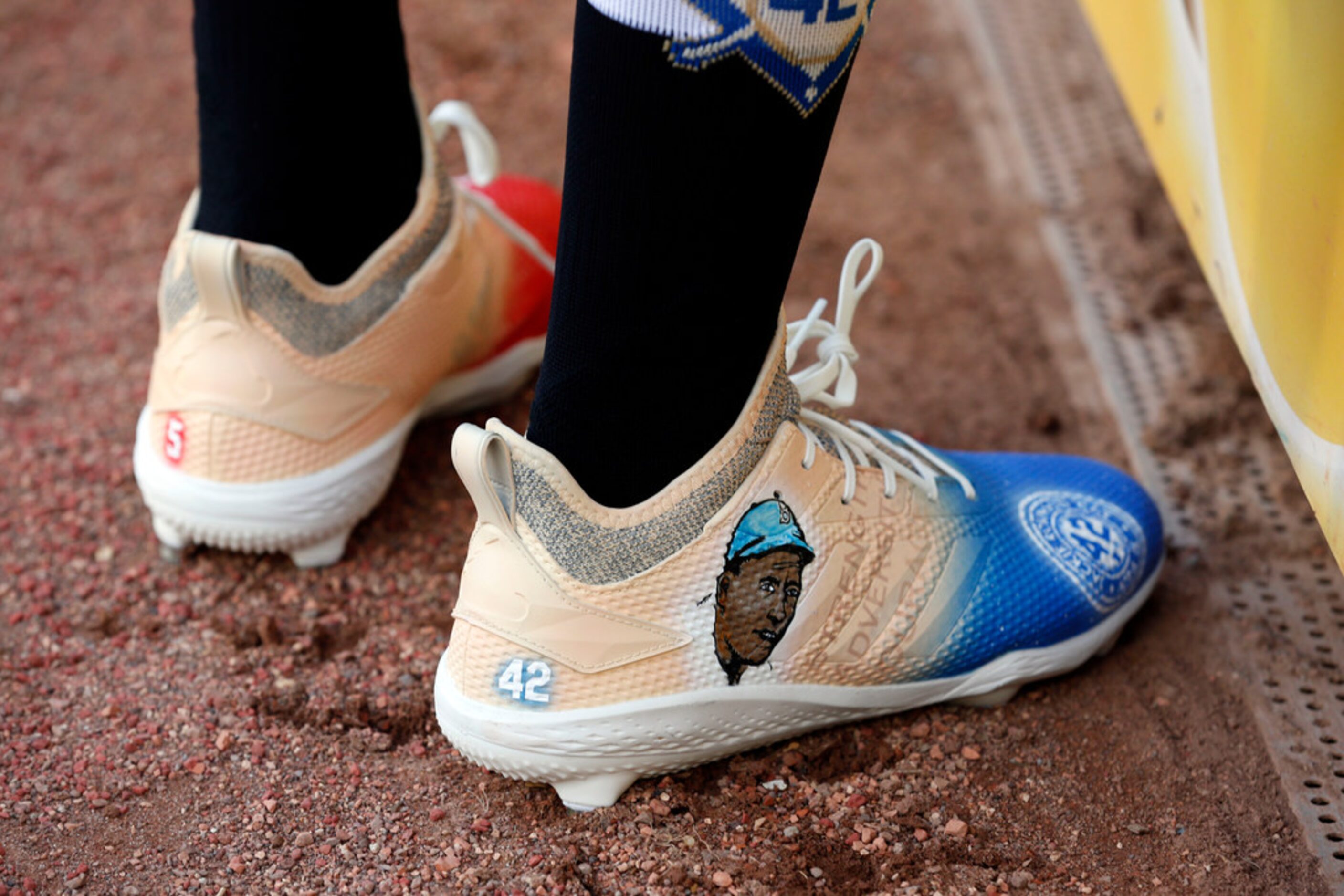 Texas Rangers' Delino DeShields wears shoes with Jackie Robinson's image prior to playing...