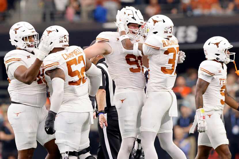 Texas Longhorns defensive end Ethan Burke (91) is congratulated on his second quarter fumble...