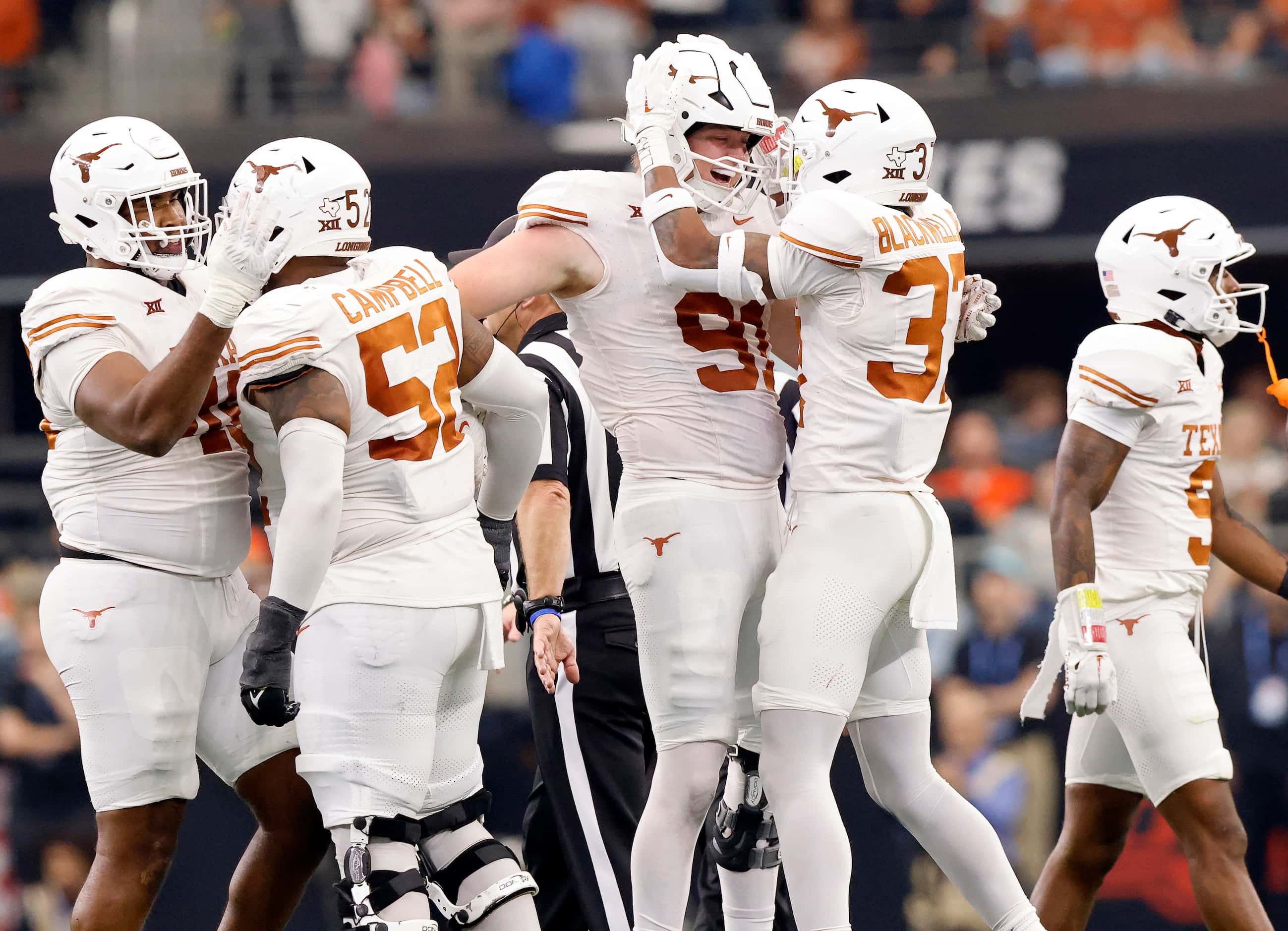 Texas Longhorns defensive end Ethan Burke (91) is congratulated on his second quarter fumble...
