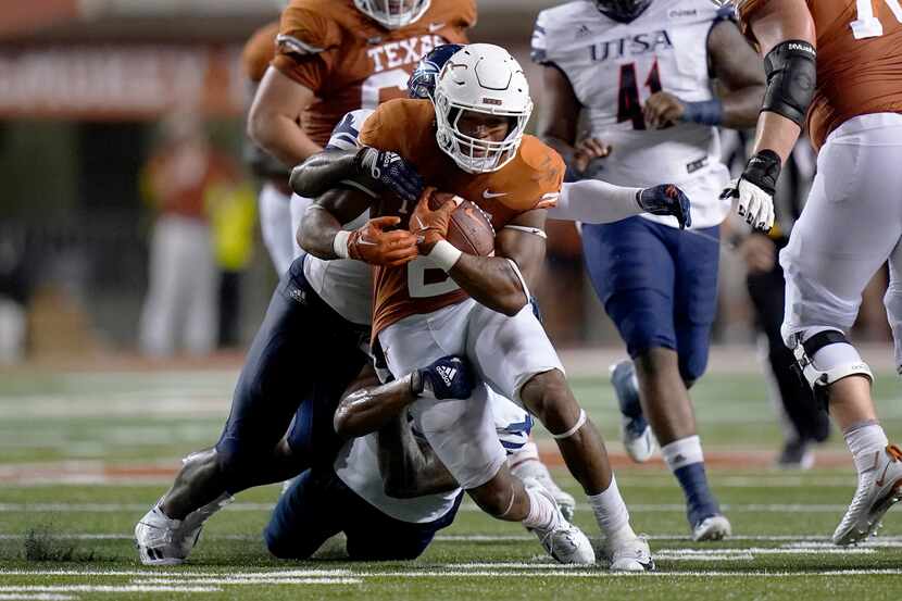 Texas running back Roschon Johnson (2) is hit on a run against UTSA during the first half of...