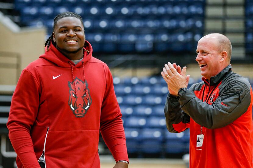 Mansfield Legacy football coach Chris Melson (right) congratulates senior defensive tackle...