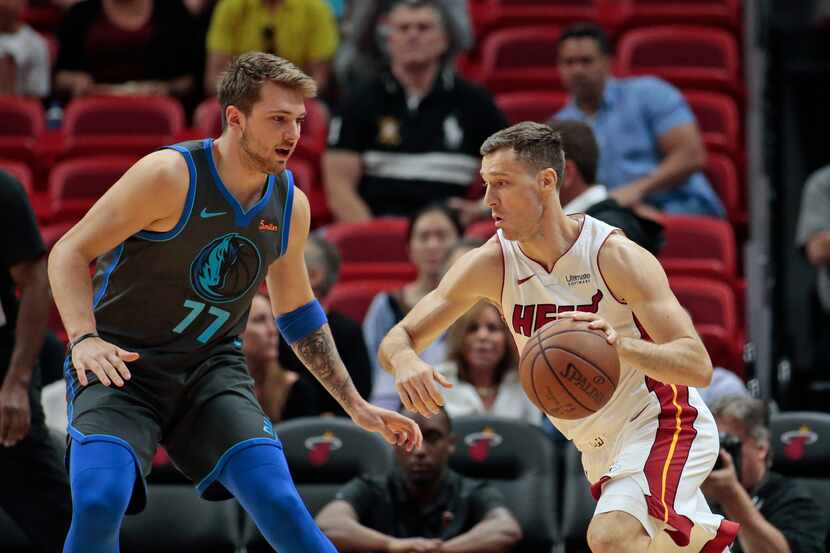 Miami Heat guard Goran Dragic (7) dribbles the ball against Dallas Mavericks forward Luka...