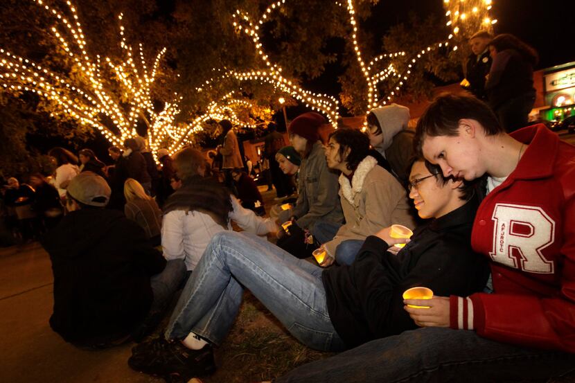 Reyna Cox, left, and Evan Adams hold candles during a Transgender Day of Remembrance event...