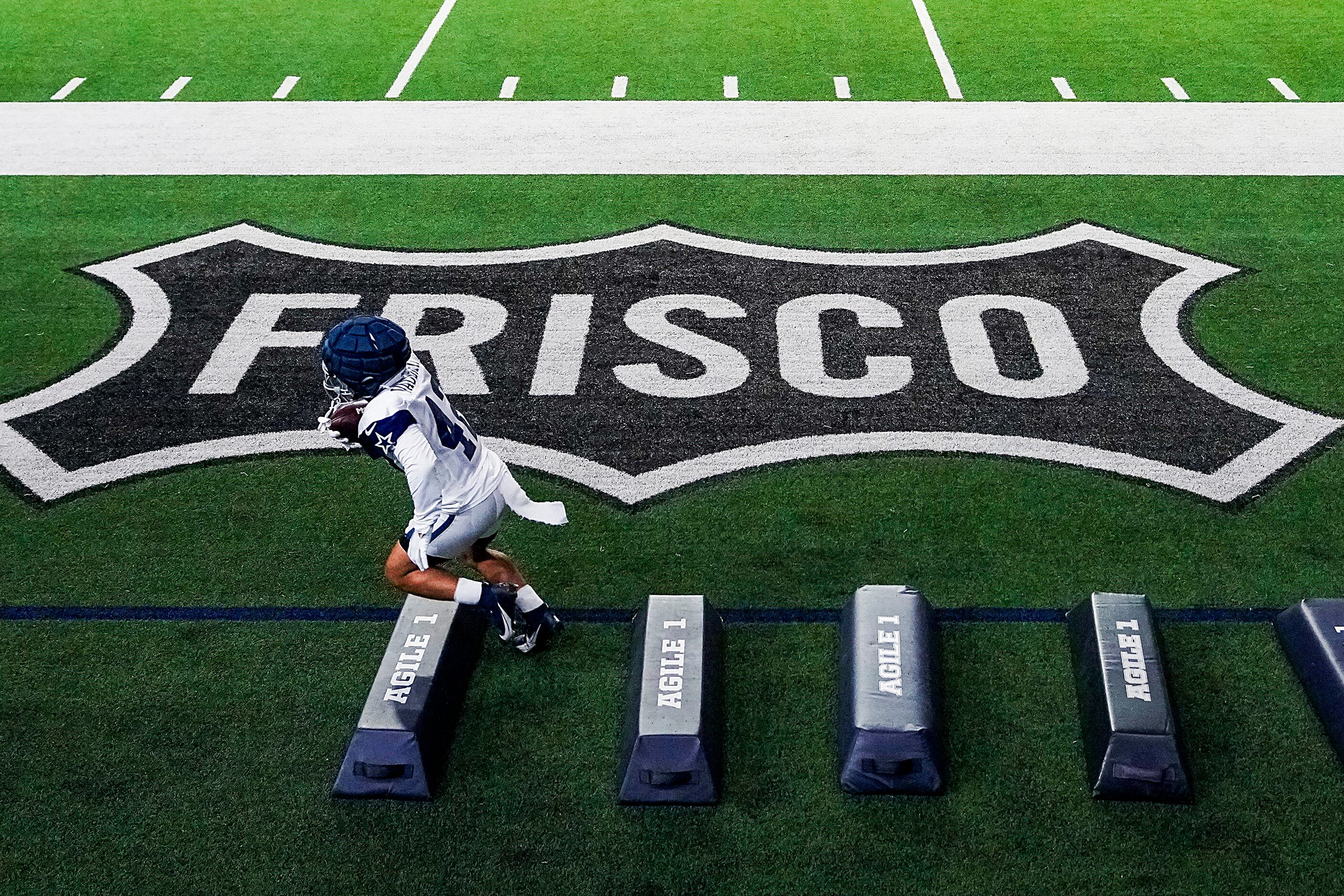 Dallas Cowboys running back Deuce Vaughn (42) runs a drill during the team’s first public...