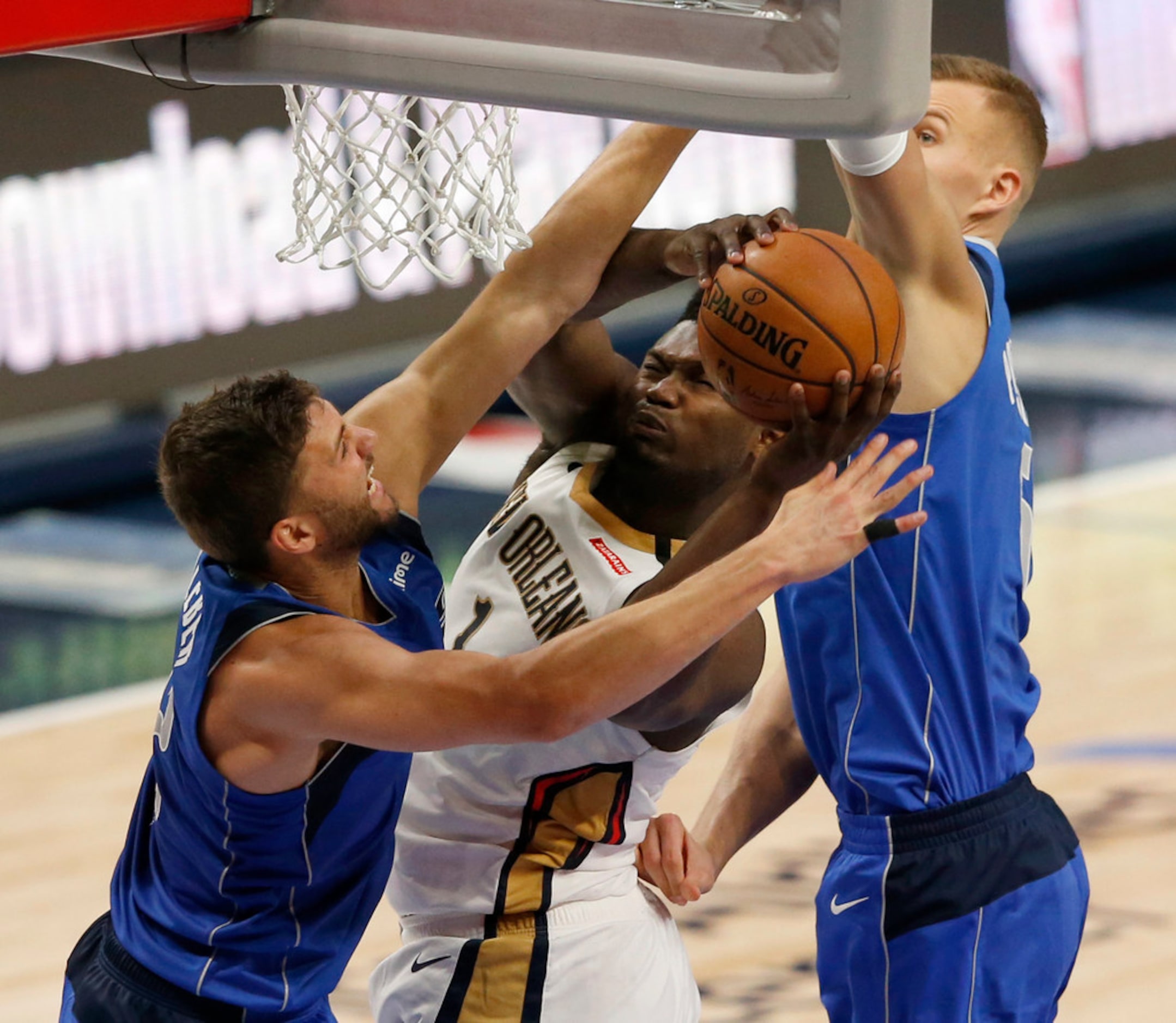 New Orleans Pelicans forward Zion Williamson (1) is is fouled as he goes up against Dallas...