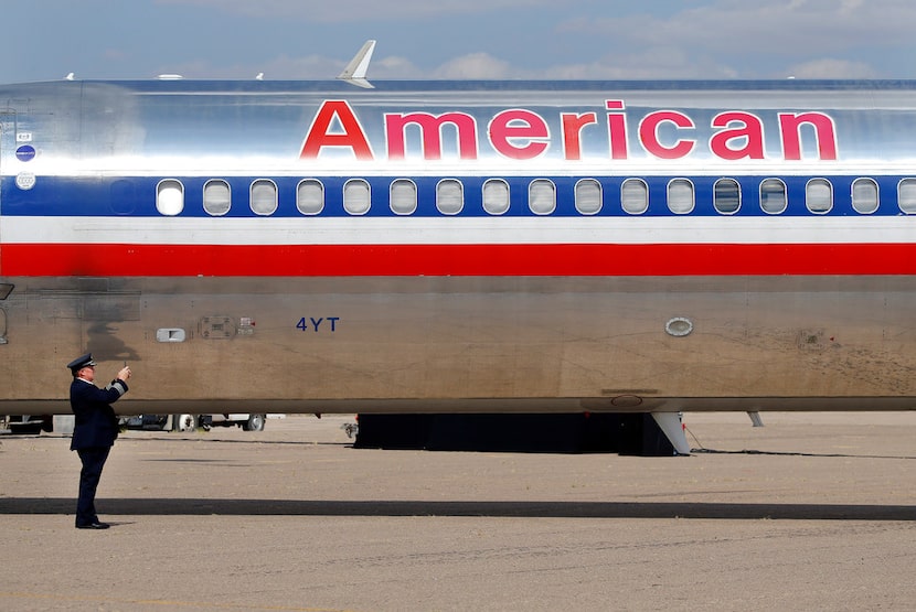 American Airlines Captain Steve Stricklin takes a photo of the MD-80 he ferried from...