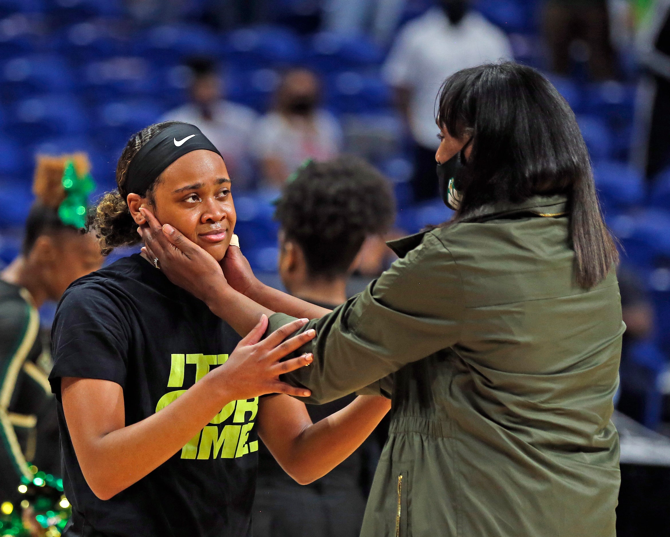 An emotional DeSoto Kendall Brown #23 is congratulated by DeSoto head coach Andrea Robinson...