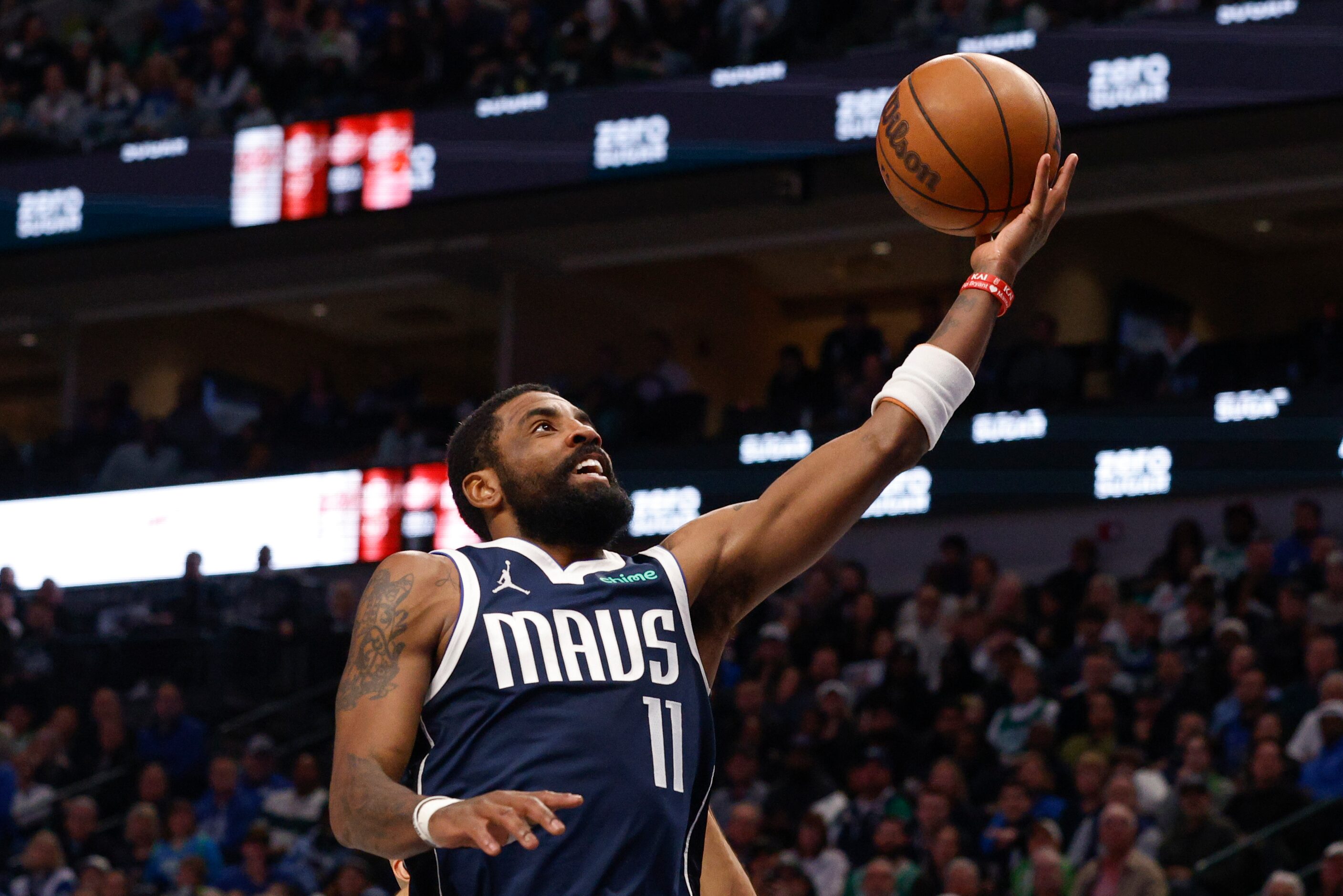 Dallas Mavericks guard Kyrie Irving (11) attempts a layup during the second half of an NBA...