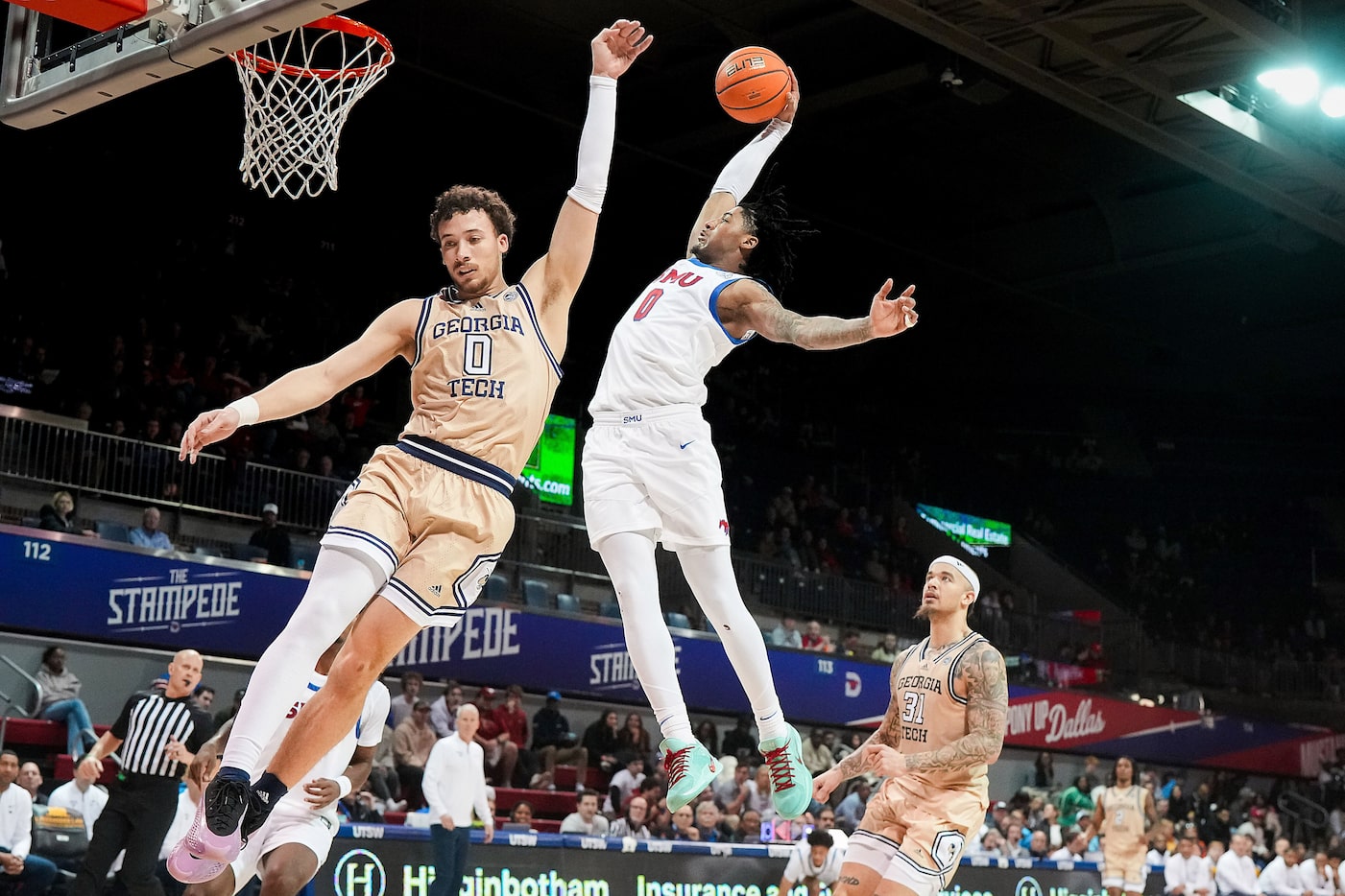 SMU guard B.J. Edwards dunks the ball over Georgia Tech guard Lance Terry during the second...