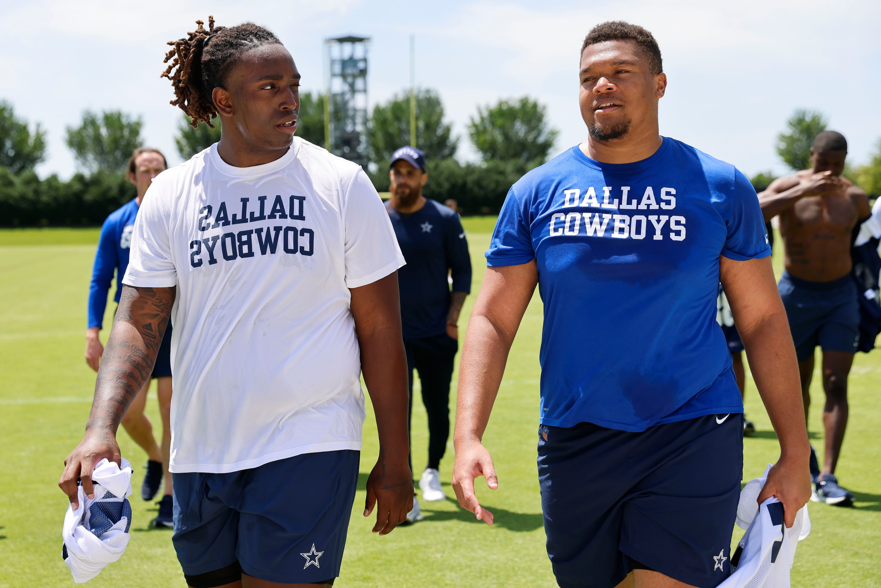 Dallas Cowboys offensive line Tyler Guyton (left) and Earl Bostick exit the field following...