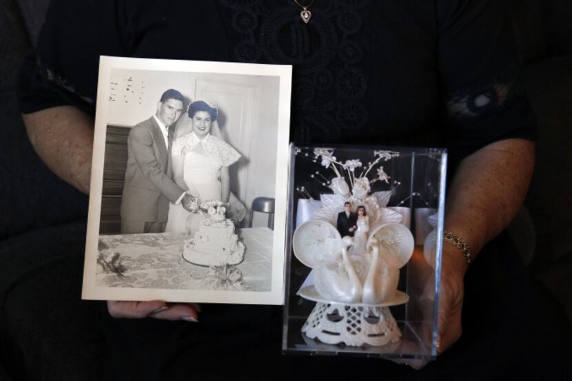 Joan Few shows her wedding photo and original cake topper that they used for their wedding...