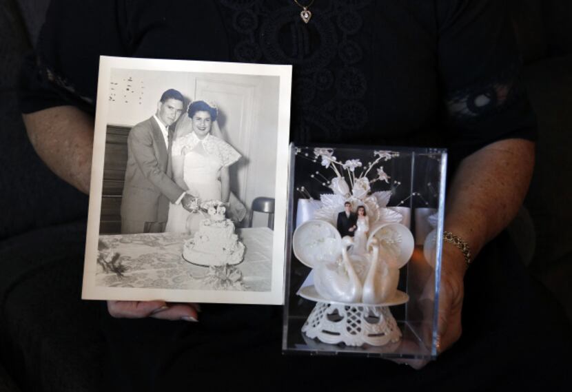 Joan Few shows her wedding photo and original cake topper that they used for their wedding...