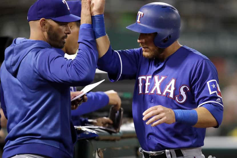 Texas Rangers' Jeff Mathis, right, is congratulated after scoring against the Oakland...