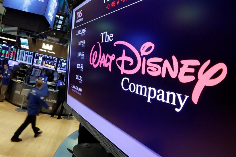 FILE - In this Aug. 8, 2017, file photo, The Walt Disney Co. logo appears on a screen above...
