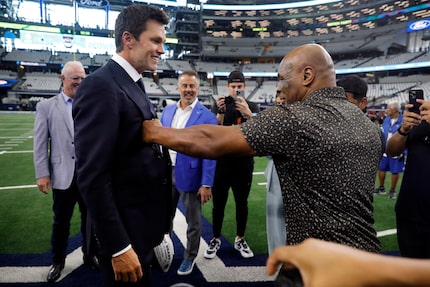 Boxer Mike Tyson delivers a light punch to FOX sports broadcaster Tom Brady as they met...