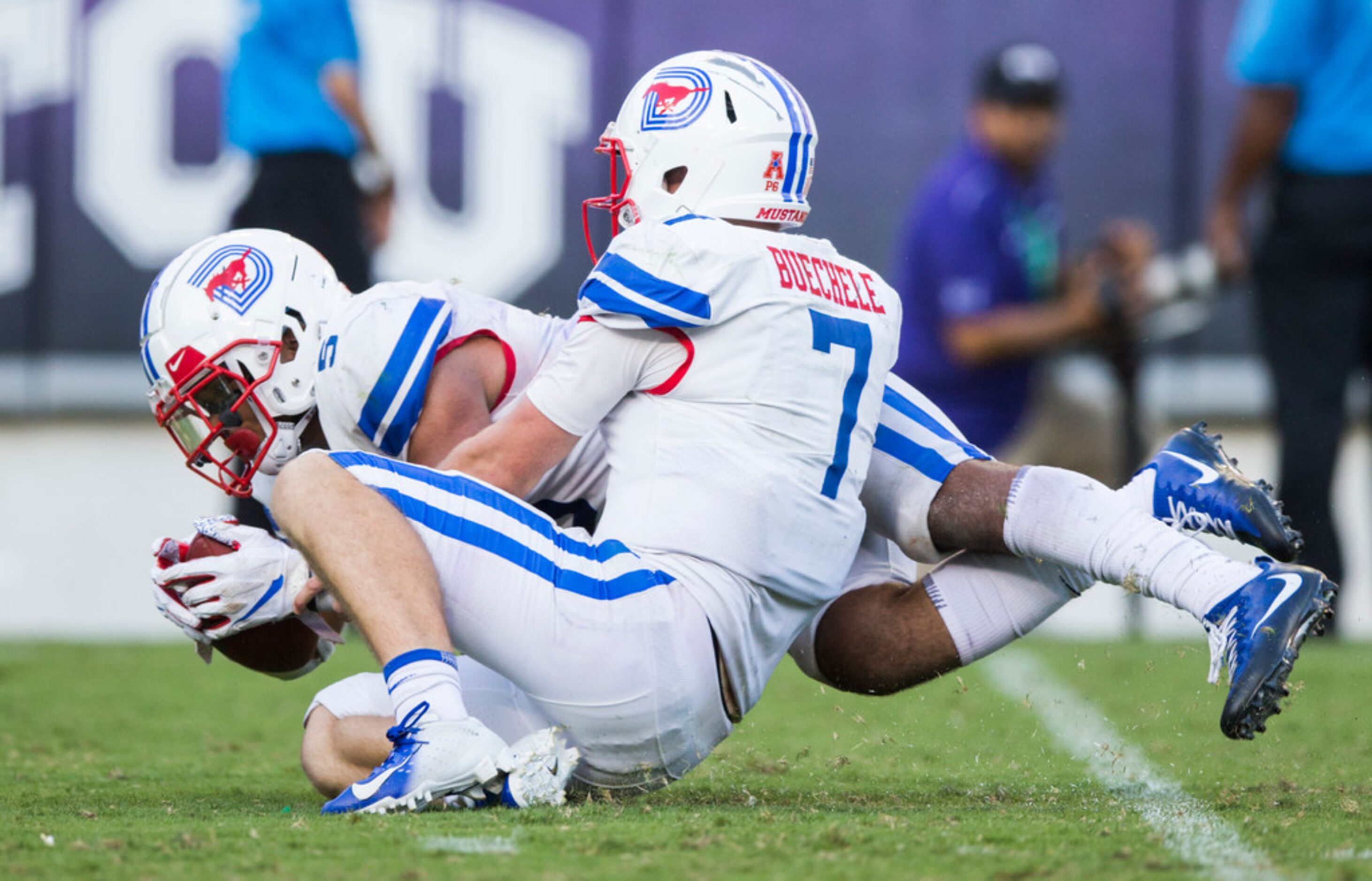 Southern Methodist Mustangs running back Xavier Jones (5) and quarterback Shane Buechele (7)...