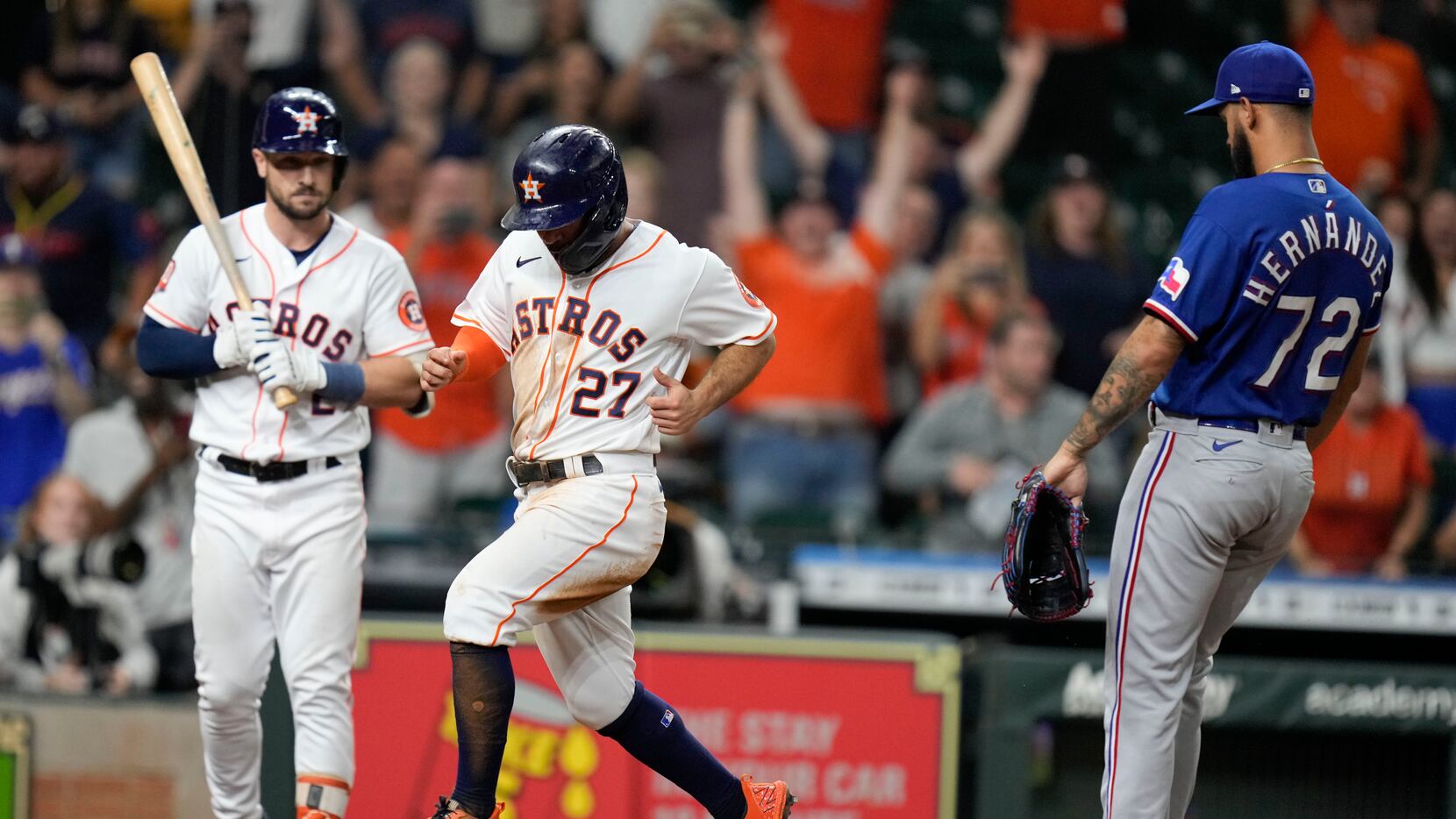 Houston Astros' Jose Altuve (27) scores the winning run on a wild pitch by Texas Rangers...