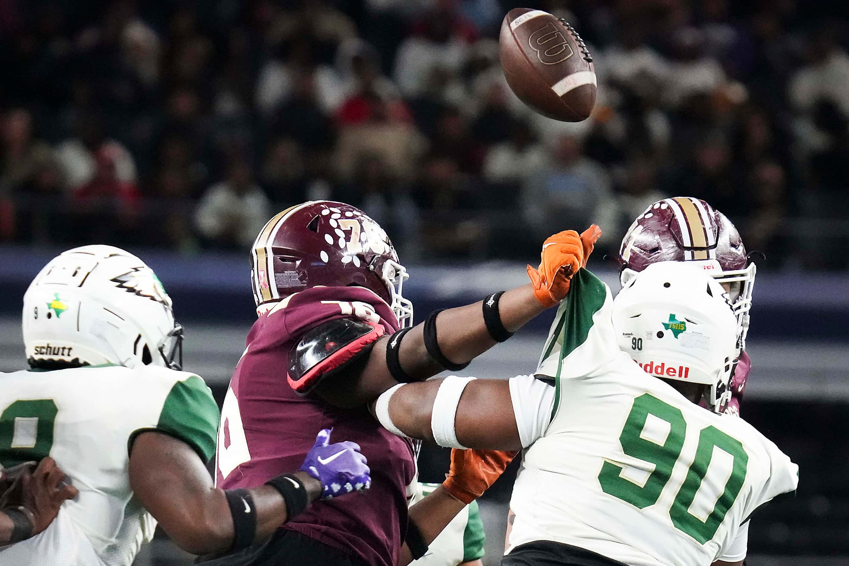 A tipped ball bounces over DeSoto defensive lineman Jirus Guy Jr (90) before being...