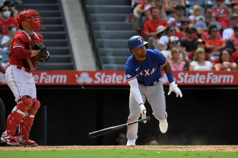 Texas Rangers' Ezequiel Duran, right, runs to first as he hits a three RBI double as Los...