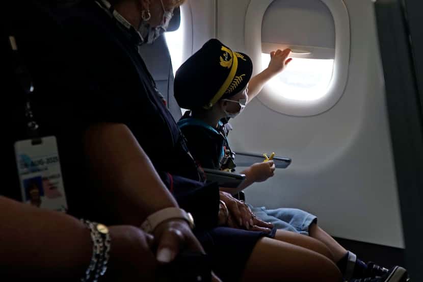 Three-year-old Kanin Nightingale looked out the window on a plane at DFW International...