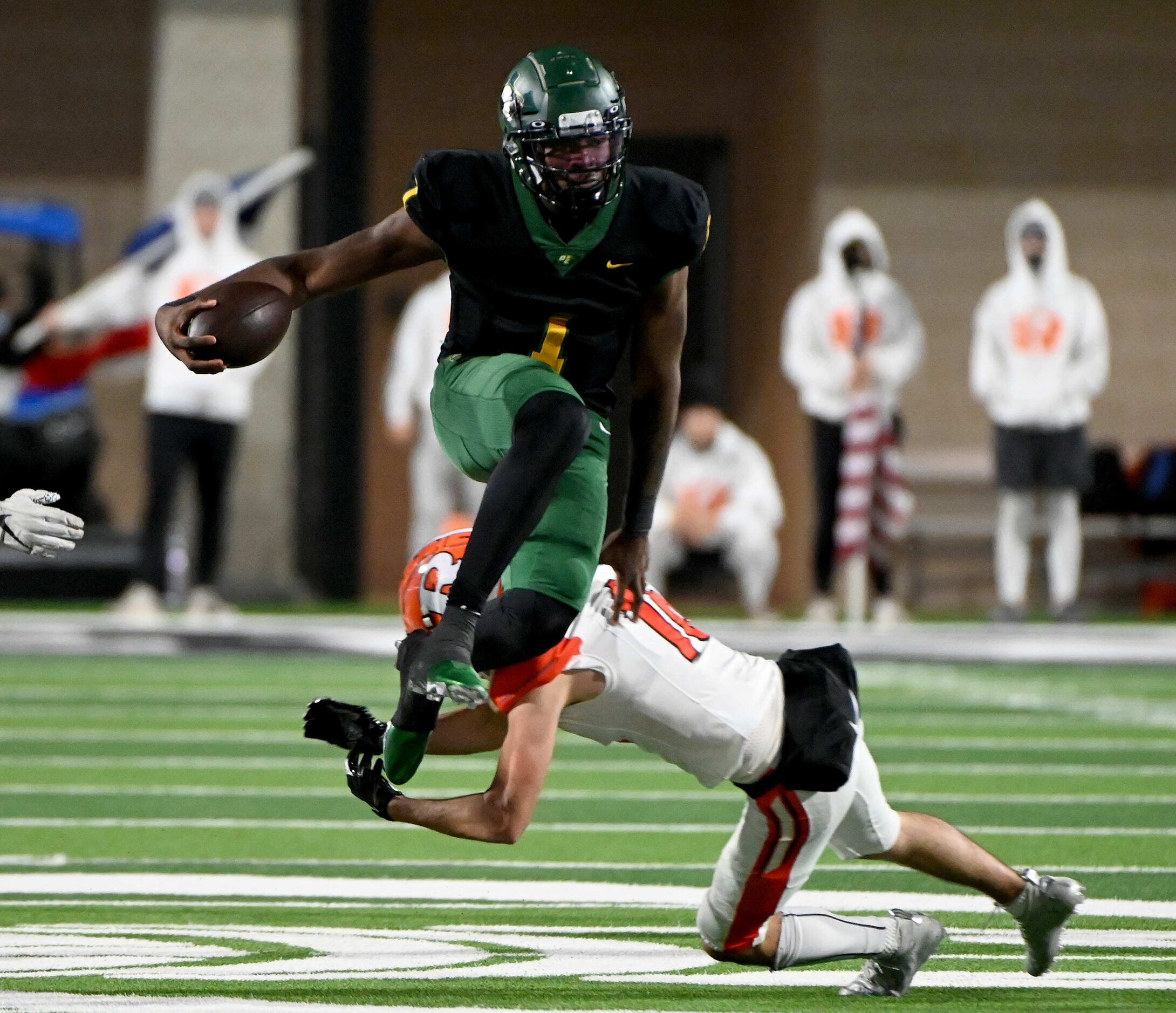 DeSoto’s Samari Collier hurdles Rockwall’s Garrett Lewis in the second half of a Class 6A...