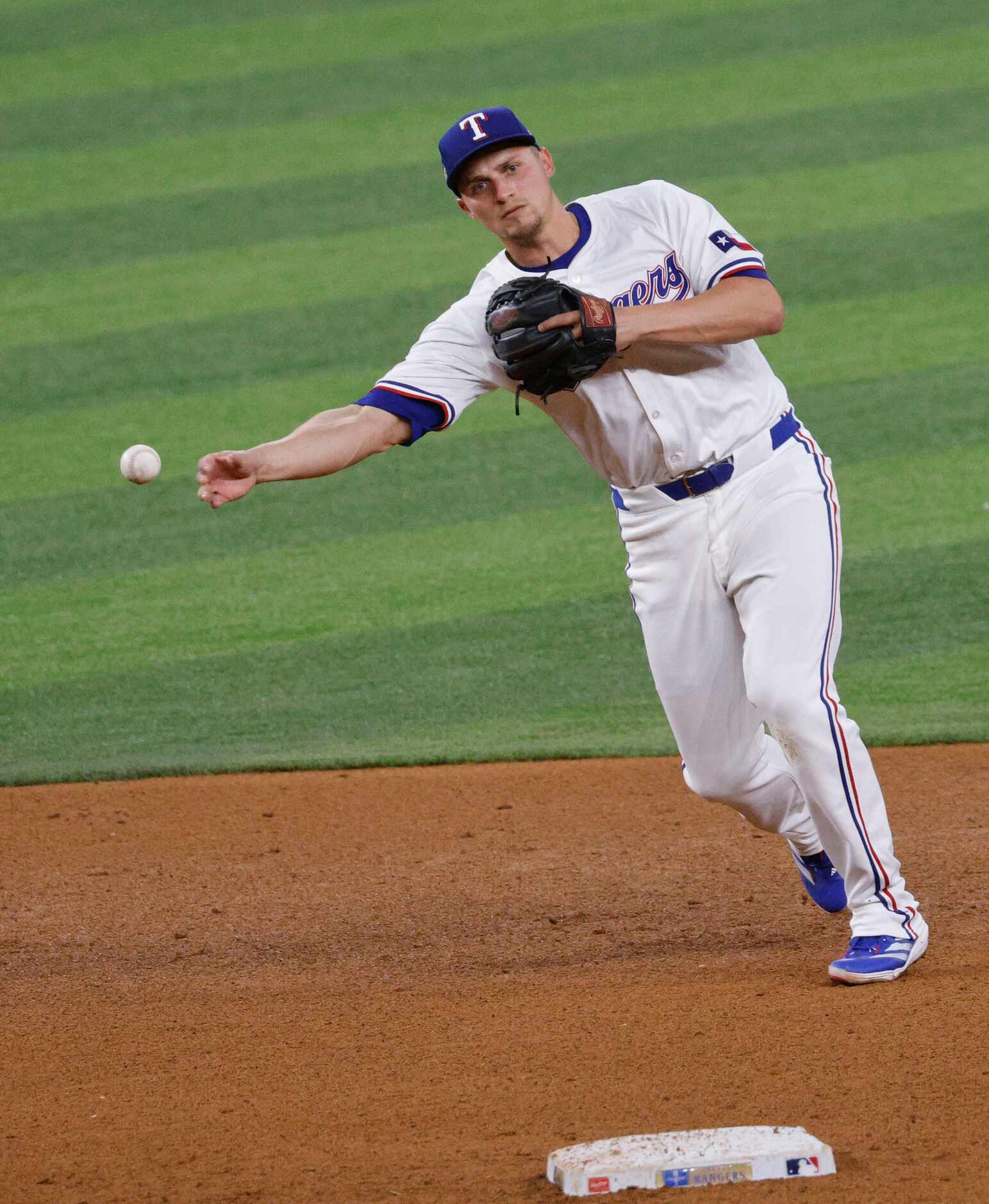 Texas Rangers shortstop Corey Seager (5) throws to first before Texas Rangers outfielder...