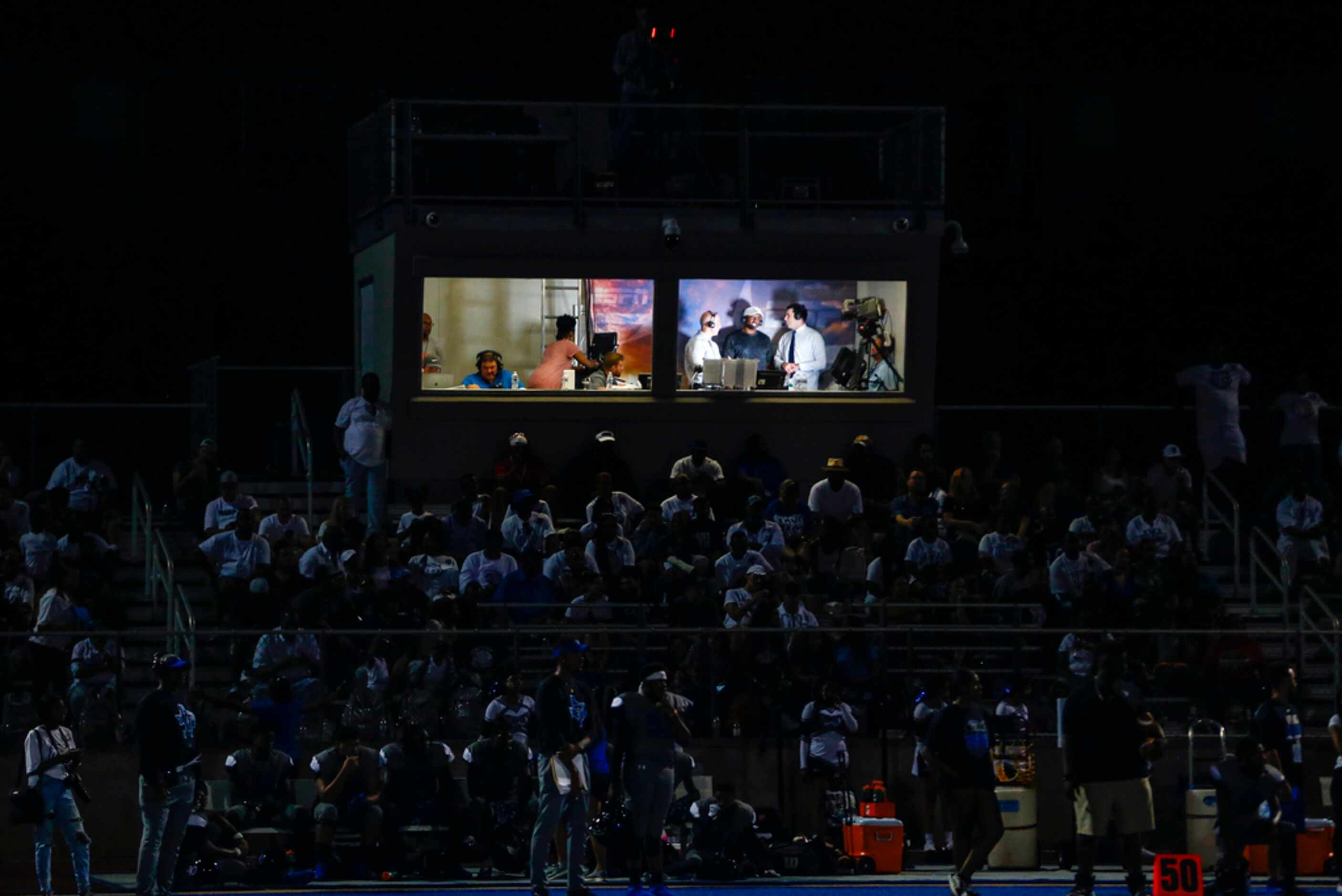 ESPN conducts an interview in a press box during a high school football game between Parish...