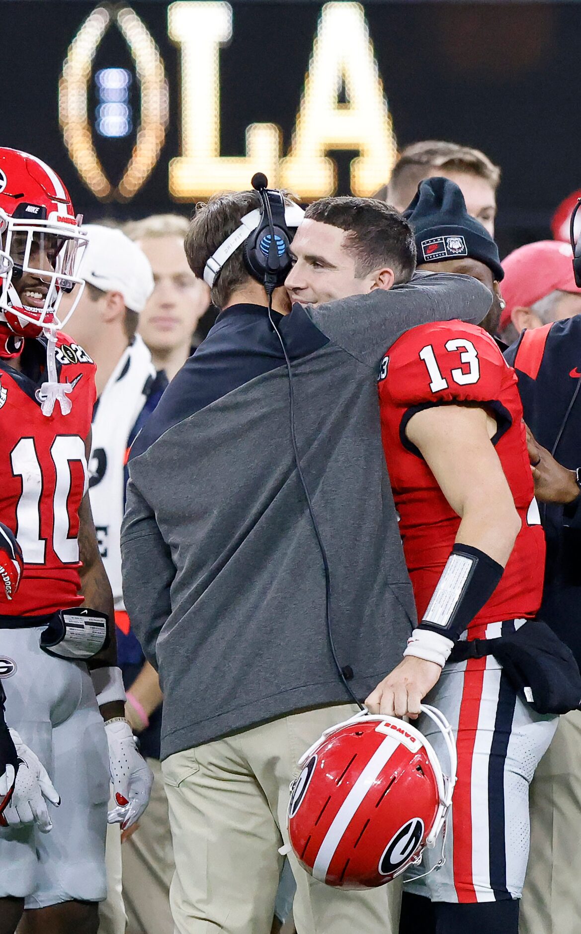 Georgia Bulldogs quarterback Stetson Bennett (13) receives a hug from his head coach Kirby...