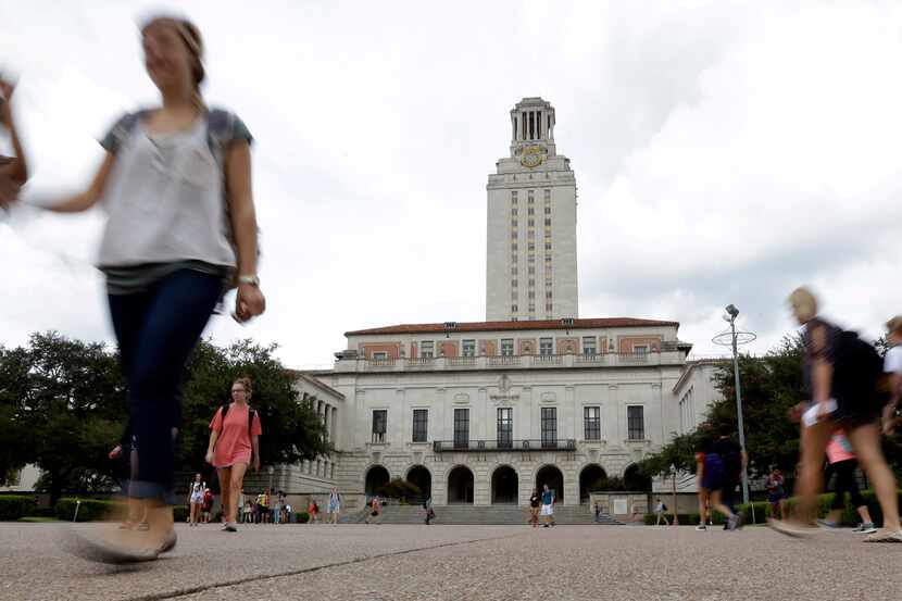 Students walk through the University of Texas at Austin campus near the school's iconic tower.