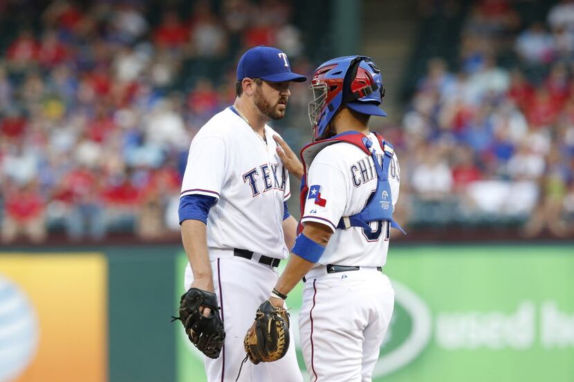 Jun 3, 2014; Arlington, TX, USA; Texas Rangers catcher Robinson Chirinos (61) talks with...