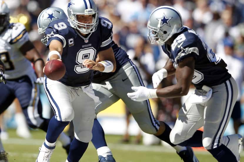 Dallas Cowboys quarterback Tony Romo (9) hands the ball off to Dallas Cowboys running back...