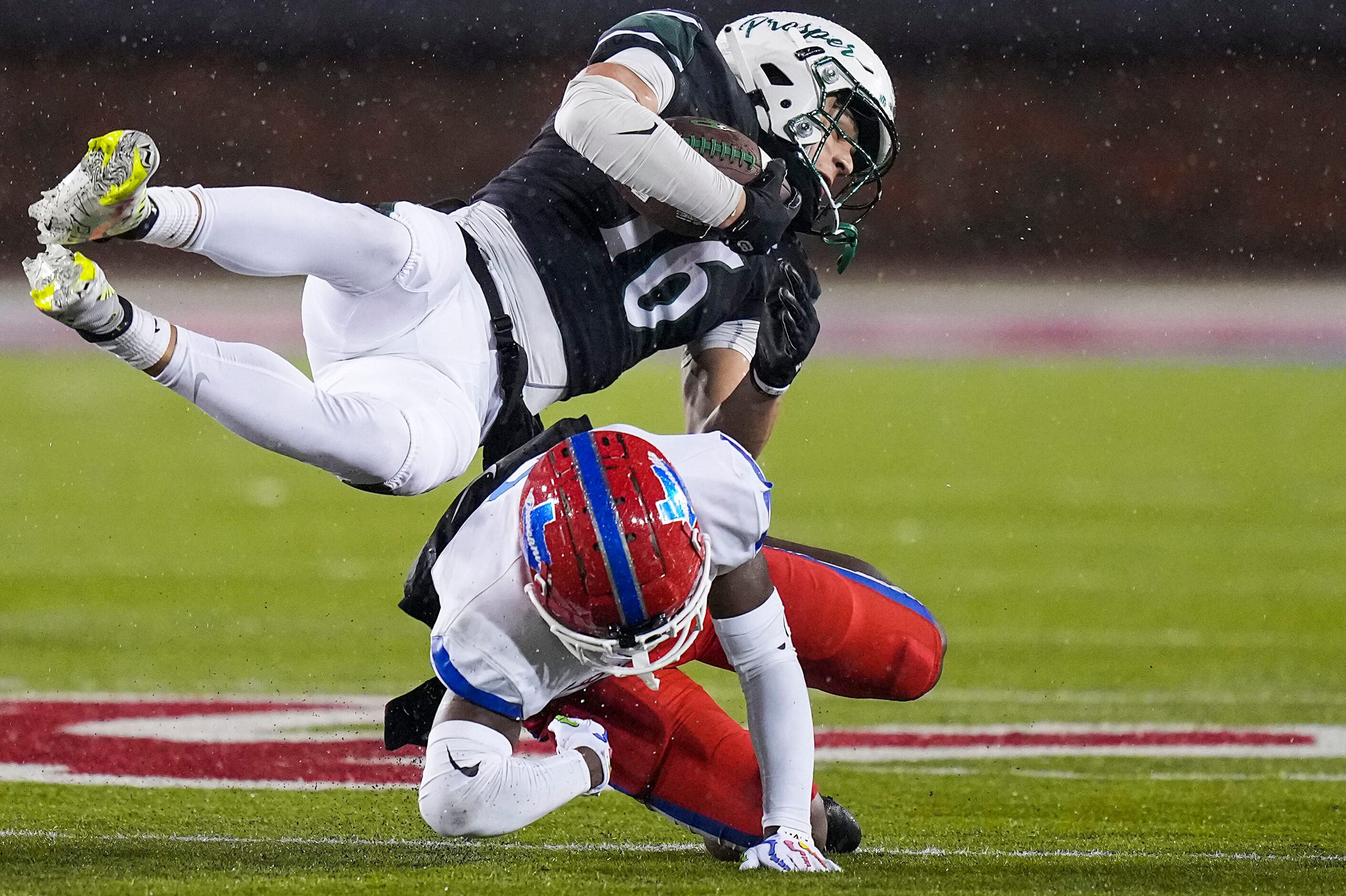 Prosper wide receiver Trevor Montanye (16) is knocked off his feet by Duncanville defensive...