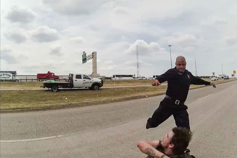 A frame from a police body camera shows Dallas paramedic Brad Cox during an altercation with...