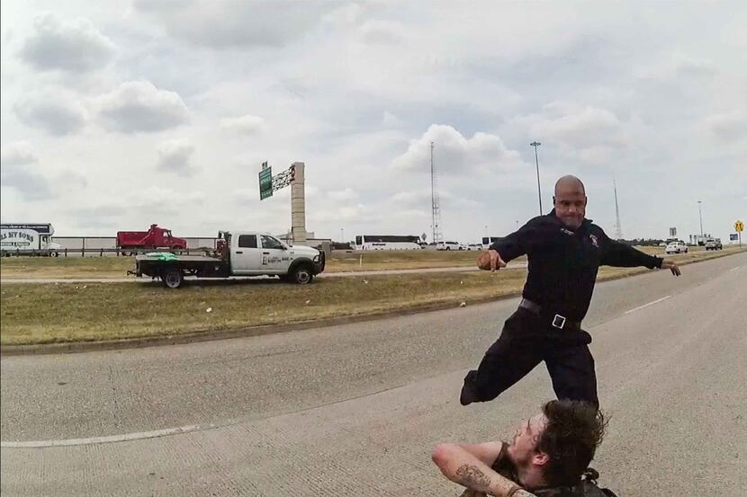 A frame from a police body cam showing  Dallas firefighter Brad Cox during an altercation...