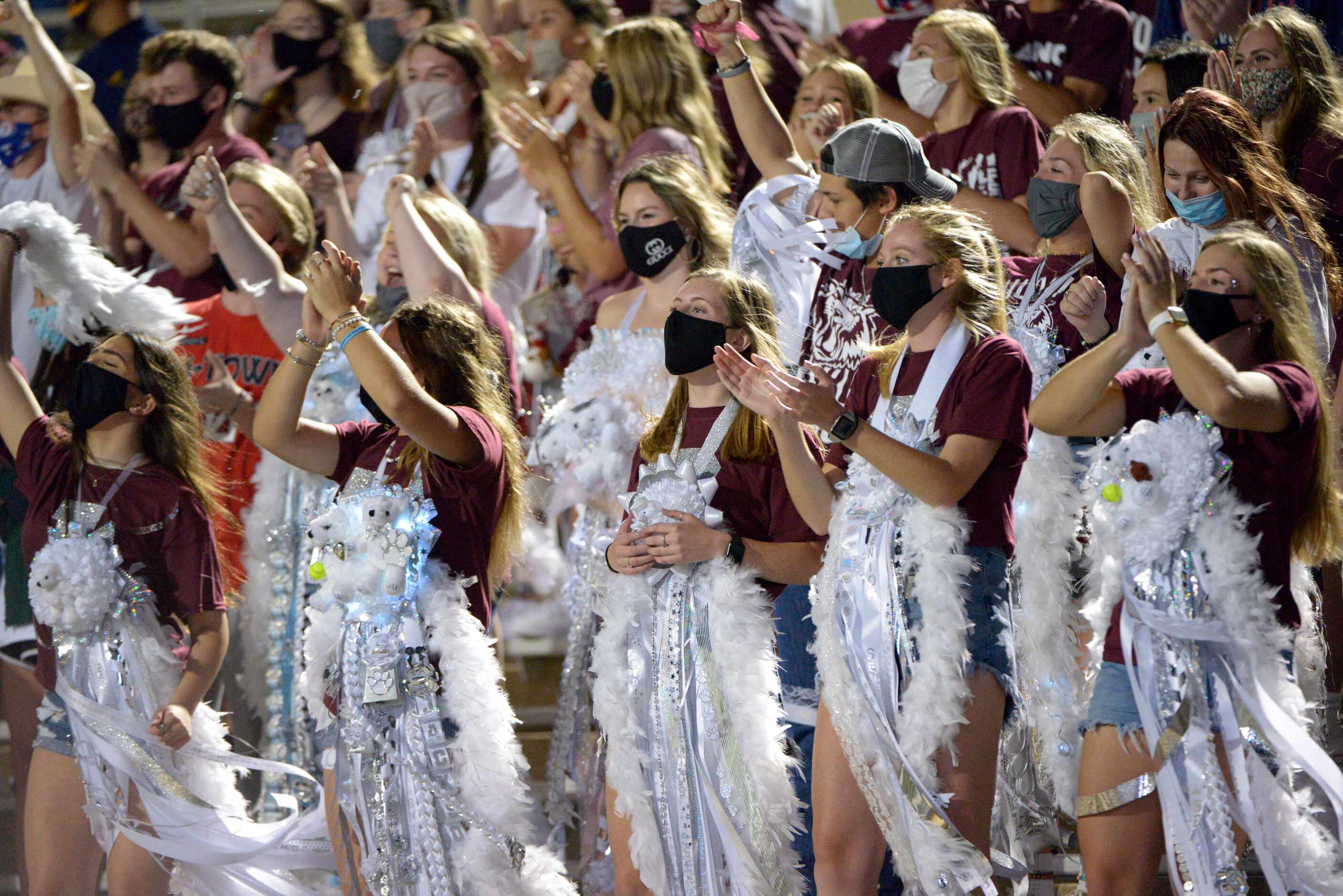 Plano students celebrate after a touchdown in the first quarter of a high school football...