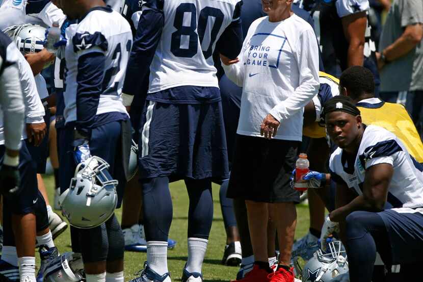SMU basketball coach Larry Brown talks to Dallas Cowboys Rico Gathers during OTA practice at...