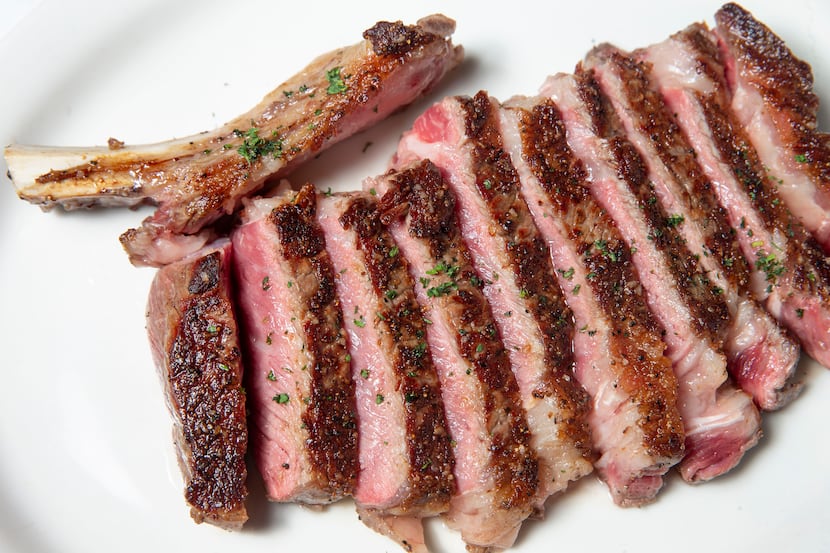 Sliced bone-in ribeye steak at Bob's Steak and Chop House in Dallas on Wednesday, May 1,...