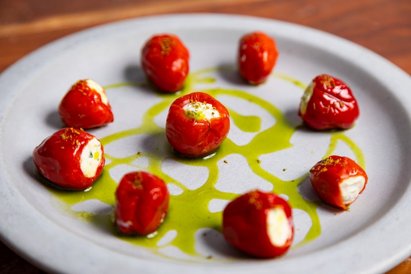 Peppadew peppers, fresh ricotta, fine herbs, green garlic and parsley oil at Osteria il Muro