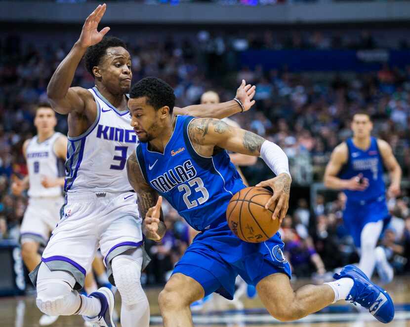 Dallas Mavericks guard Trey Burke (23) leans in to Sacramento Kings guard Yogi Ferrell (3)...