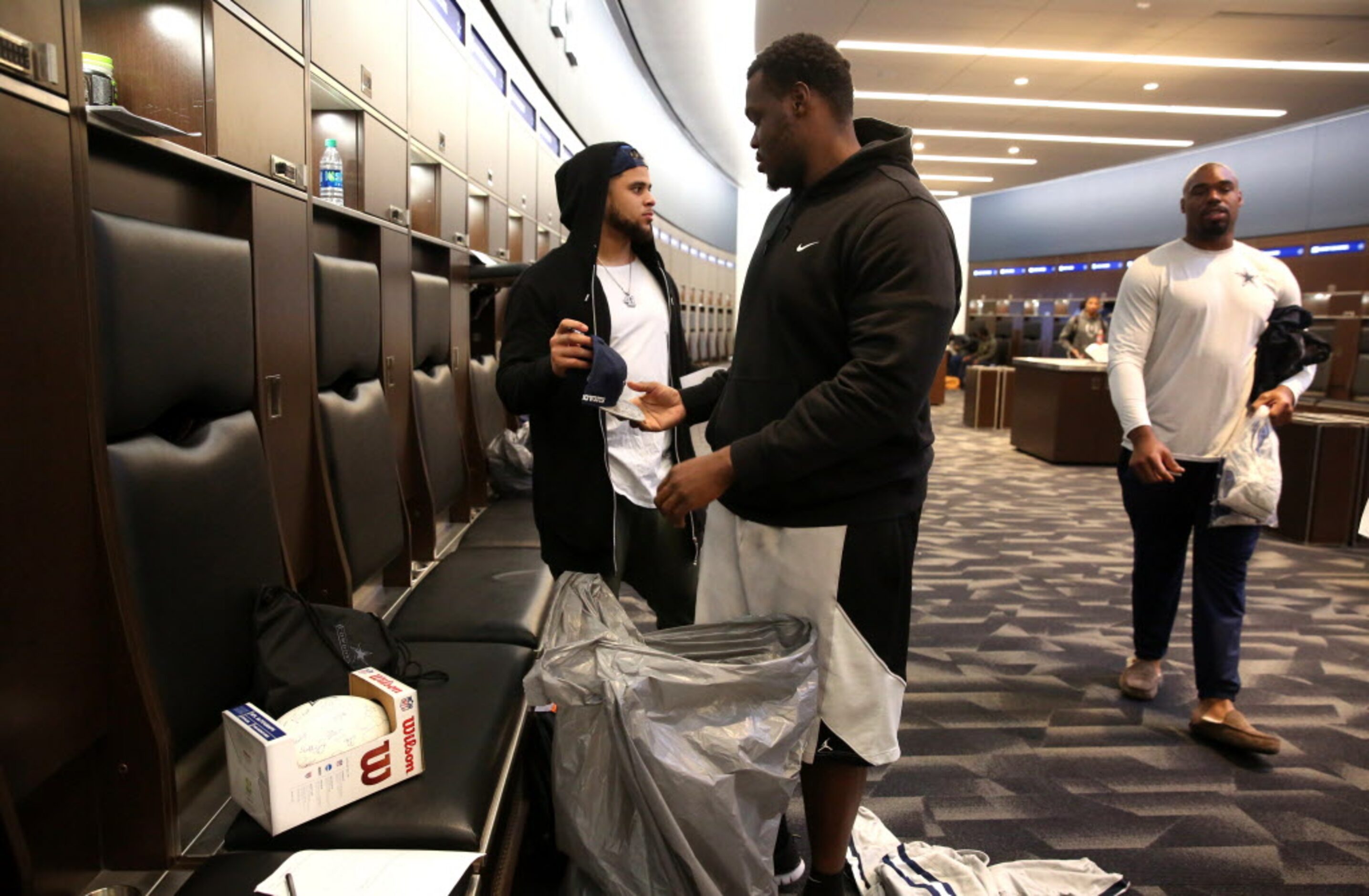 Dallas Cowboys fullback Keith Smith gets guard Kadeem Edwards to sign his cap during locker...