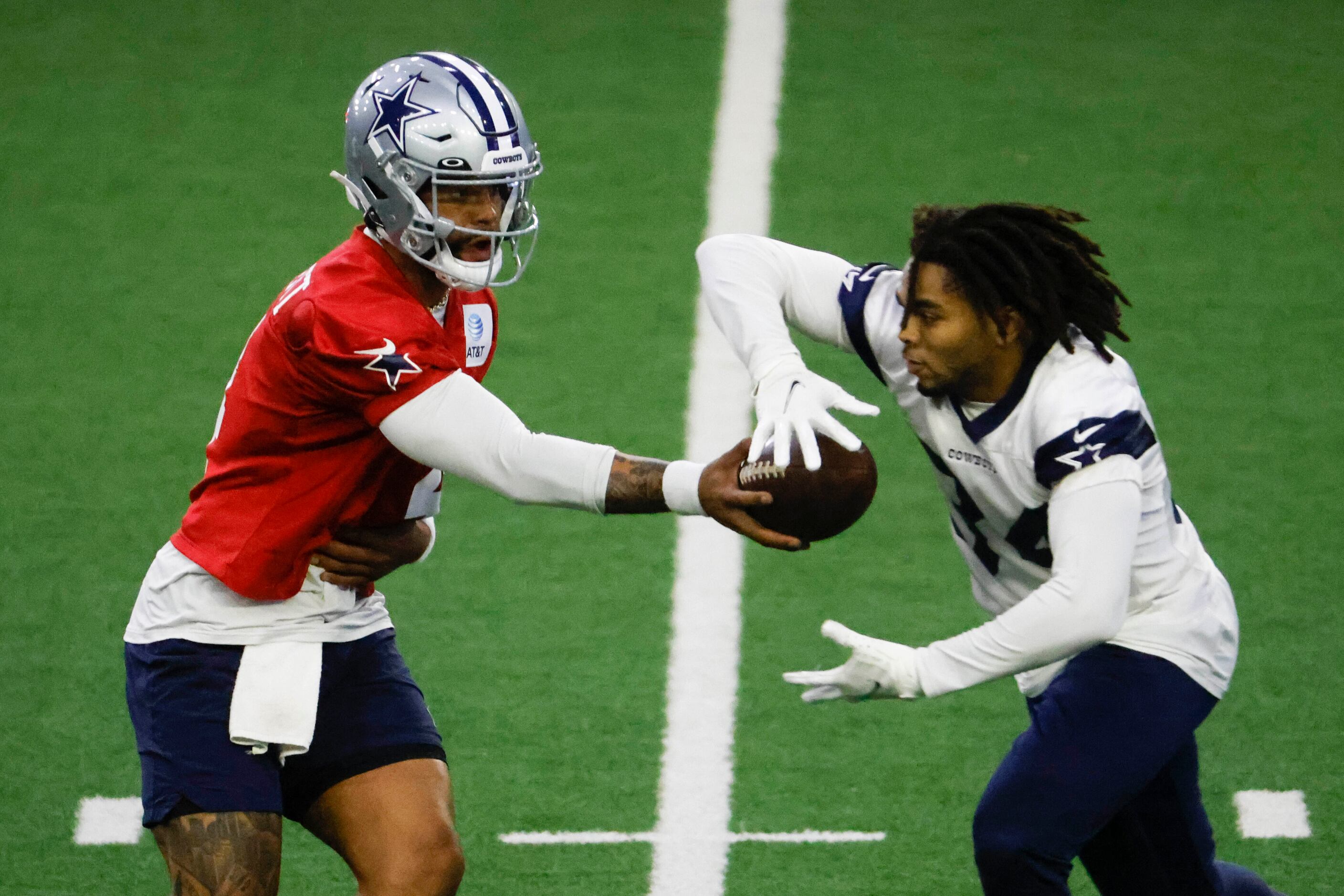 Dallas Cowboys quarterback Dak Prescott (4) hands off the ball to Dallas Cowboys running...